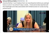 a woman is sitting at a table in front of a camera