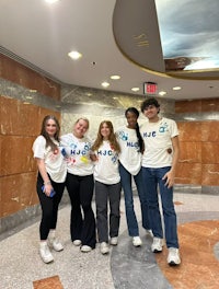 a group of people posing for a photo in a lobby